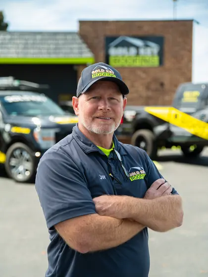 Gold Key Roofing team member outside the office
